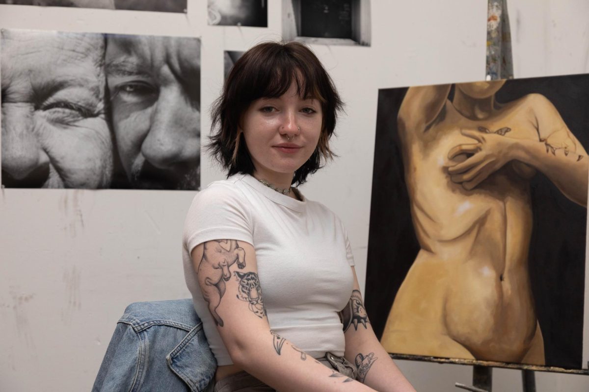 Hez Sumner sits in their personal studio space.